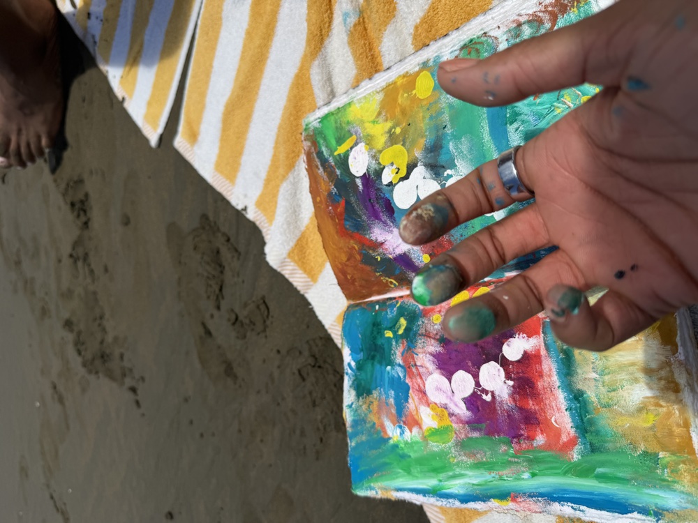 The artist at work, paint on her hands